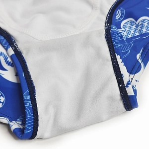 Detailed close-up of swimwear inner lining with blue crane print and secure stitching
