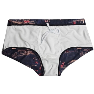 Detail of floral print waistband and adjustable drawstring on men's swim trunks