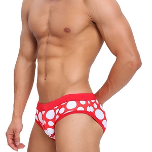 Men's low-waisted swim briefs in red with white polka dots for beach and fitness