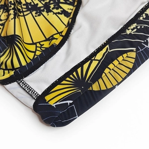 Macro shot of yellow fan print swim trunks with high-stretch fabric and fine stitching