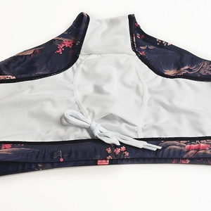 Detail of floral swim trunks with breathable white mesh lining and flat drawstring
