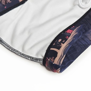 Detail of printed men's swim shorts featuring white mesh lining and black edge stitching