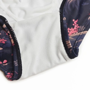 Close-up of breathable white knit inner lining and floral print fabric on swim shorts