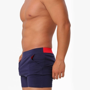 Detail view of men's slim fit cotton boxer shorts with red elastic waistband and side pockets
