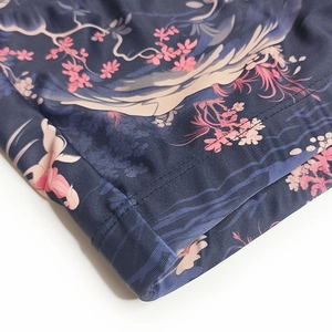 Detail of men's swim trunks featuring Japanese wave print and double-stitched hem