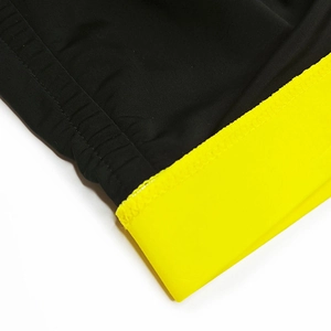 Close-up of contrast stitching and textured fabric on men's color-block swimming trunks