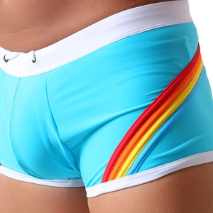 Detail of blue athletic swim trunks featuring rainbow side stripes and white waist trim