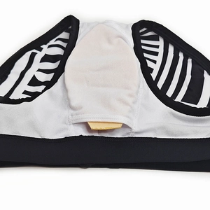 Detail view of swimwear interior featuring white mesh lining and removable cup padding