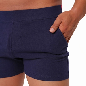 Macro shot of men's cotton blend shorts showing pocket detail and elastic waistband texture