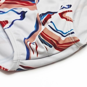 Detailed close-up showing high-density stitching and abstract marble print on men's swimwear