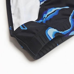 Detail of blue wave print on men's swimwear with elastic stitching and mesh lining