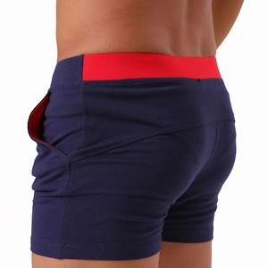 Detail of navy cotton boxer shorts with red contrast waistband and functional side pockets