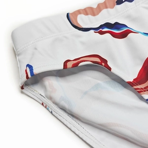 Detailed close-up of elastic waistband and modern abstract print on men's swim briefs