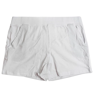 Detailed macro view of white cotton lounge shorts featuring elastic waistband and side pockets