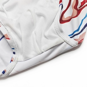 Detailed view of white quick-dry fabric with blue and red printing and fine stitching