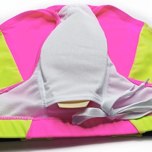 Detail of neon pink and green swim briefs with breathable mesh lining and drawstring