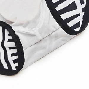 Macro view of men's low-rise swim briefs with black and white zebra print and mesh lining