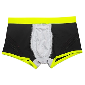 Detail of men's athletic swim trunks with neon yellow elastic waistband and breathable mesh