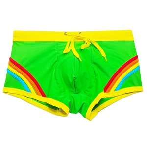 Detailed flat lay of bright green swim trunks with rainbow side stripes and yellow drawstring