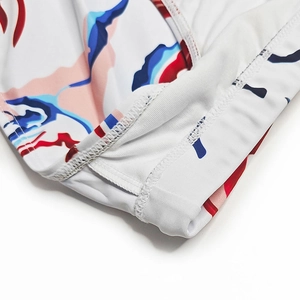 Detail of colorful cloud print on swim trunks featuring high-quality stitching and fabric