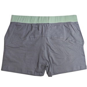 Detail view of cotton boxer shorts with grey fabric and light green elastic waistband