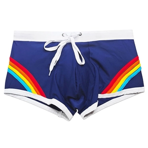 Detail of navy swim trunks with rainbow curved stripes and adjustable white drawstring