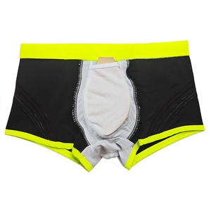 Detail view of black men's swimming trunks with neon yellow trim and breathable inner pouch