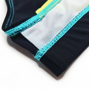 Detail of flatlock stitching and breathable white mesh lining on men's swim briefs