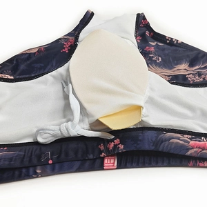 Detail of swim trunks featuring floral print, breathable mesh lining, and removable pad