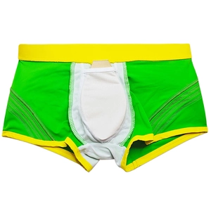 Detail of green swim trunks showing internal white protective liner and ergonomic cup pocket
