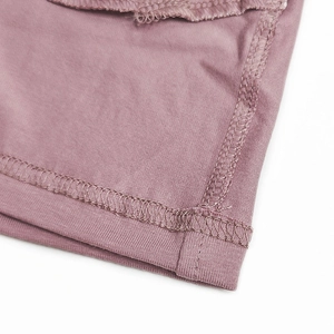 Detail of dusty rose cotton boxer shorts showing high-quality flatlock stitching seams