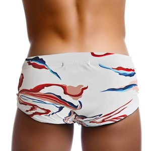Close-up back view of men's swim trunks with abstract red and blue feather prints