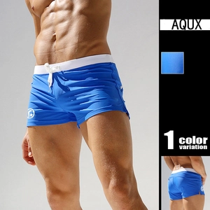 Detail view of royal blue swim trunks with white drawstring and branded round logo