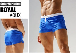 Detail view of royal blue mens low rise swim trunks with contrast drawstring and back pocket