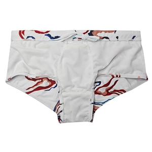 Detail view of men's printed swimming trunks with white drawstring and breathable inner lining