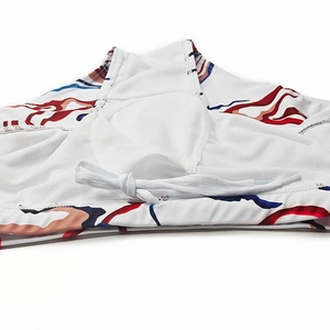 Detail of printed men's swim trunks featuring white drawstring and mesh lining