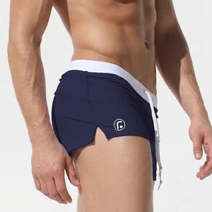 Men's low-waist navy blue swim trunks with white drawstring and logo on side