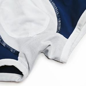Detail view of men's color-block swim trunks featuring breathable mesh and reinforced seams