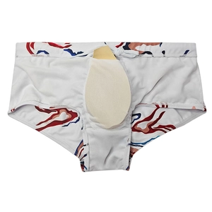 Detail of men's swim trunks featuring a removable protective pad and inner lining