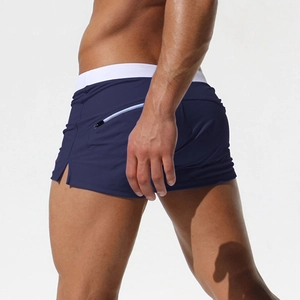 Detail of navy blue men swimming trunks with a secure zipper pocket on the back hip