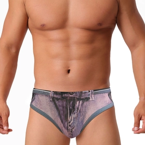 Close-up of men's swim briefs with creative distressed denim print and orange stitching