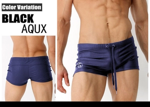 Detailed view of navy blue men's tight swimming trunks with logo and drawstring