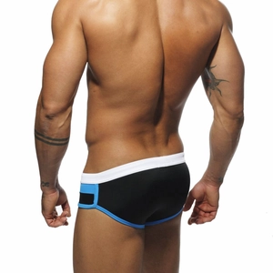 Rear view of men's color-block swimming briefs showing muscular fit and elastic fabric