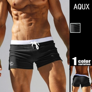 Detail of men's low-rise swim trunks showing the white drawstring and side logo emblem