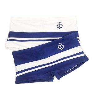 Flat lay of men's square-cut swim trunks with navy anchor prints and blue striped patterns