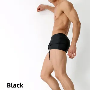 Close-up of men's black trunk swimsuit with adjustable drawstring and sleek side fit