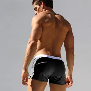 Detail of men's low-waist swim trunks with a back zipper pocket and elastic drawstring