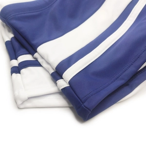 Macro shot showing blue and white striped fabric stitching details on men's swim trunks
