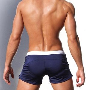 Rear view of men's navy blue quick-dry swim trunks with white waistband for surfing