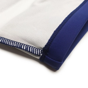 Detailed close-up of reinforced stitching and navy elastic seams on mens swim trunks
